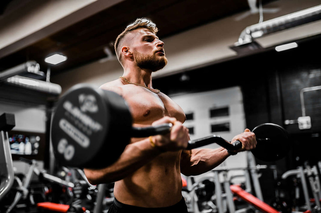 Man performing partial reps with barbell in a gym, showcasing effective strength training techniques.