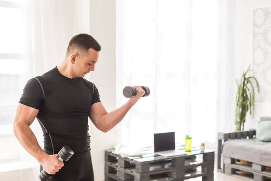 Man exercising at home with dumbbells, showcasing versatile gym equipment for strength training.