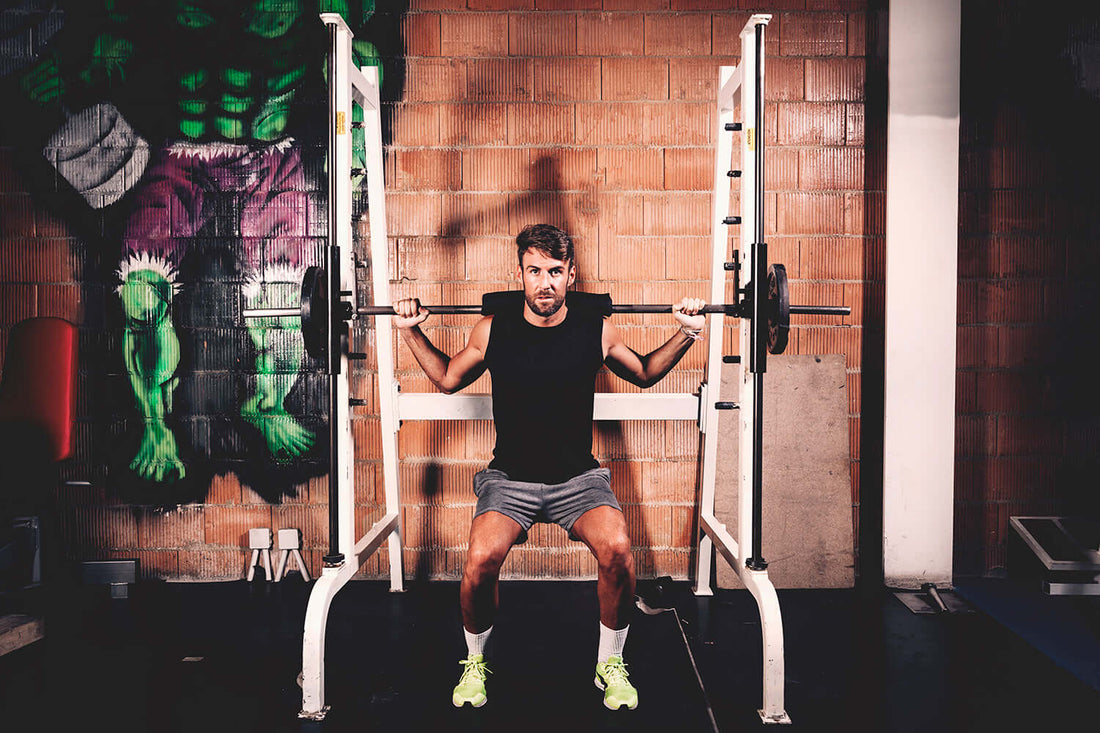 Man performing squats with barbell in gym, emphasizing strength training and effective reps for muscle growth.