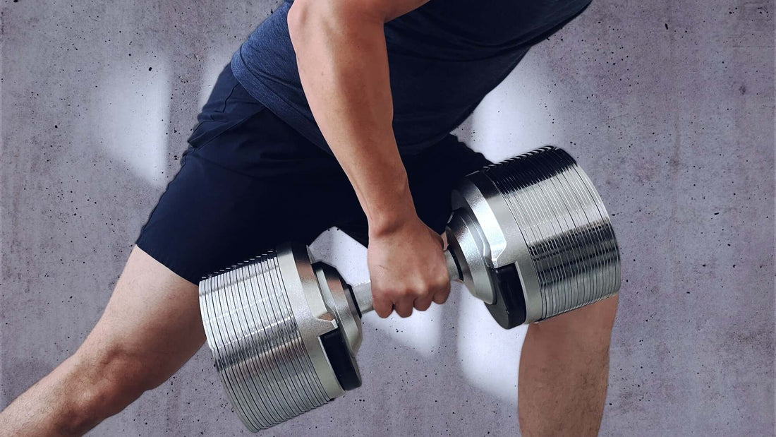 Person using adjustable dumbbells for home gym exercises in a small space.