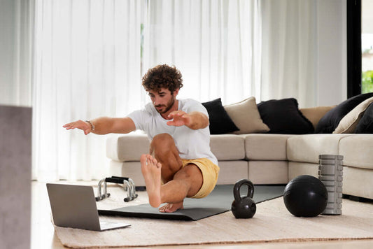 Man doing home workout with kettlebell, dumbbells, and fitness mat in living room, promoting gym equipment for 2024 home gym setup.