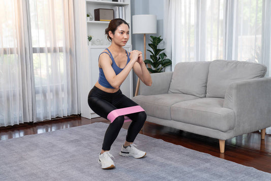 vigorous energetic woman doing exercise home resistance sport band leg