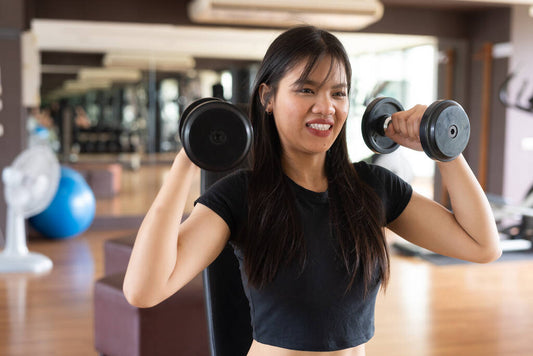 young beautiful asian fitness woman exercising gym